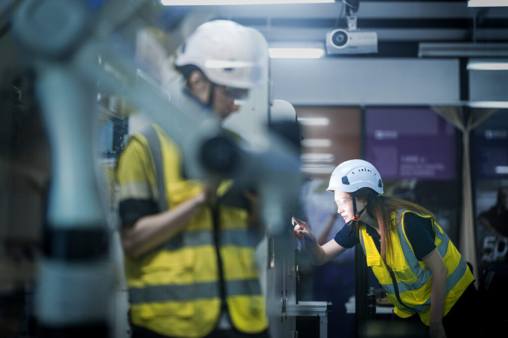 Strategic team of AI engineers collaborating on complex robotics