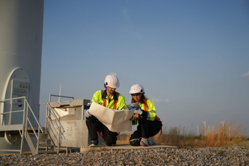 Sustainable energy industry Engineers working at alternative renewable wind energy farm
