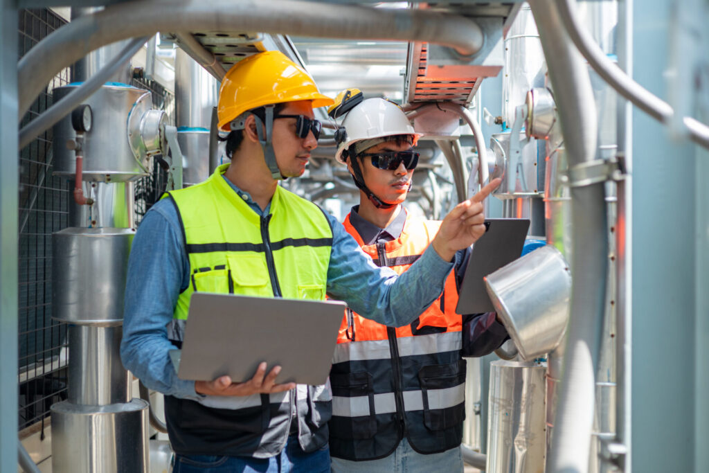 An engineer checks the status of a large AHU air conditioner control valve.