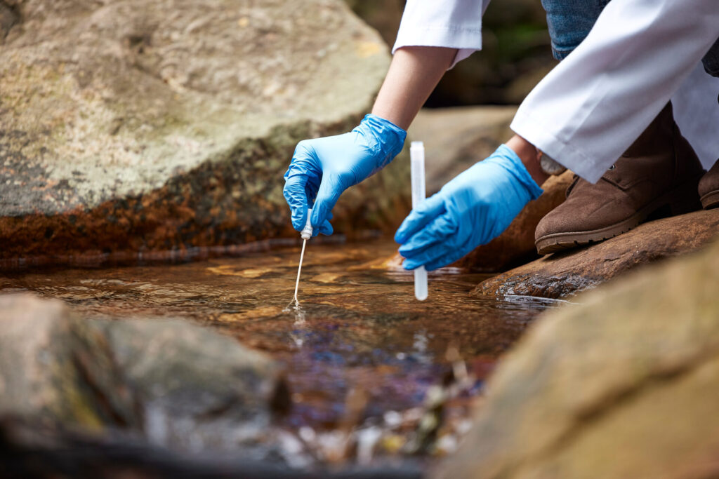 Scientist sampling water from stream in nature 2026 01 09 09 45 16 utc